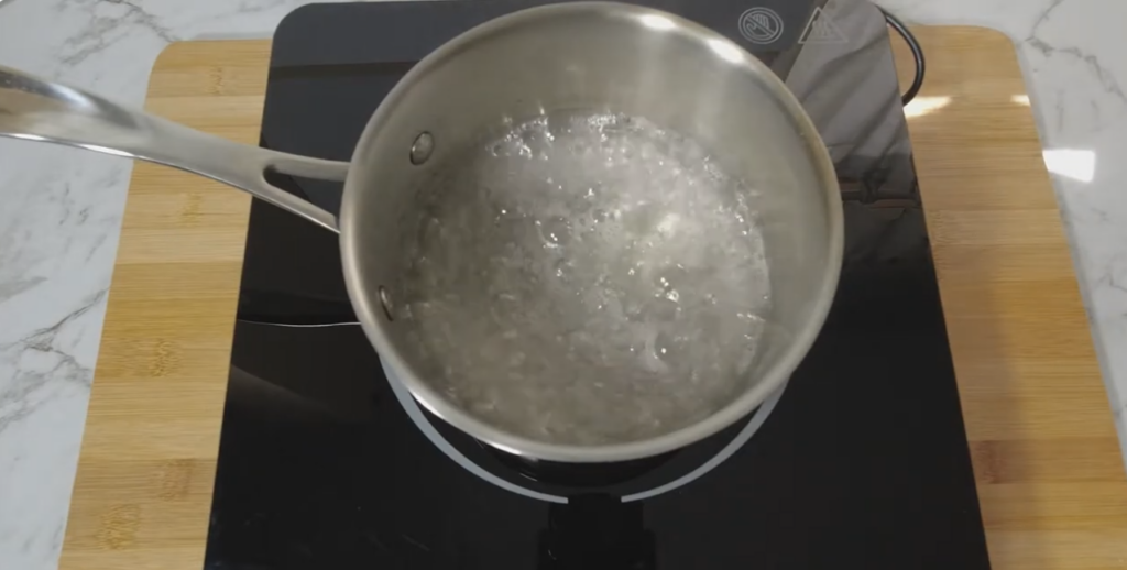 sugar, corn syrup, and water on the stovetop until it reaches 115°C