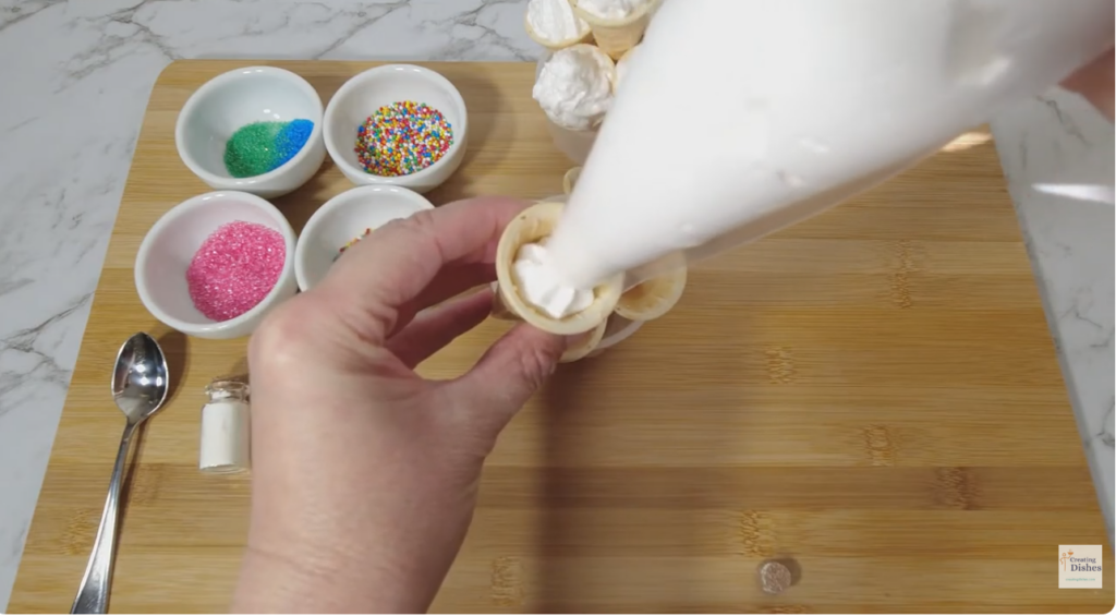 Transfer the marshmallow to a piping bag and pipe into the cones